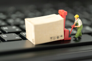 Miniature people Worker Labor pulling trolley cart for moving goods supplied box on laptop computer with copy space using transportation shipping, Supplied Delivery, rent container Forwarding concept
