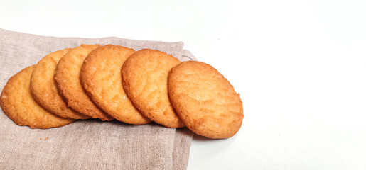 Fresh Homebaked Wheat biscuits or Cookies isolated in a White background with selective focus and copy space for inscription. 