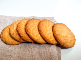 Fresh Homebaked Wheat biscuits or Cookies isolated in a White background with selective focus and copy space for inscription. 