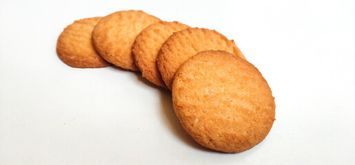 Fresh Homebaked Wheat biscuits or Cookies isolated in a White background with selective focus and copy space for inscription. 