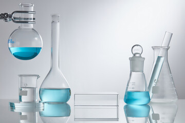 
Researchers are using glassware in laboratories, research on cosmetics and energy on white background. Stage showcase cosmetics on glass pedestal modern in laboratory equipment. Minimal concept. 