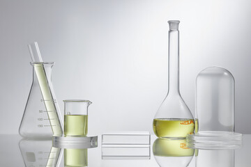 Assorted laboratory glassware equipment showcase with oil on white backround. Stage showcase...