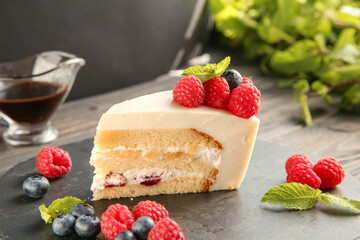 A piece of delicious cake with berries and mint