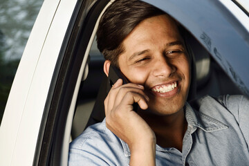 Indian Man Talking On Phone While Driving, Distracted
