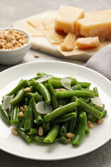 Tasty salad with green beans served on light grey table