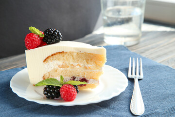 A piece of delicious cake with berries and mint
