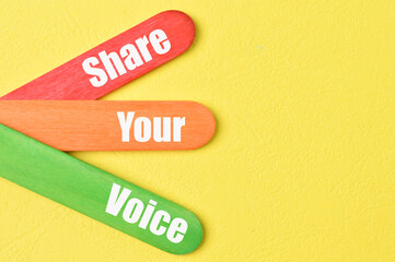 Colorful ice cream sticks with phrase SHARE YOUR VOICE