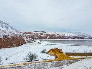 A waste heap or waste heap is a dump, an artificial embankment made of waste rock extracted during underground mining of mineral deposits. Winter landscape. Belarus. Soligorsk. Potassium salt.