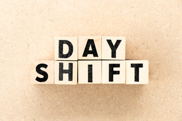 Alphabet letter block in word day shift on wood background