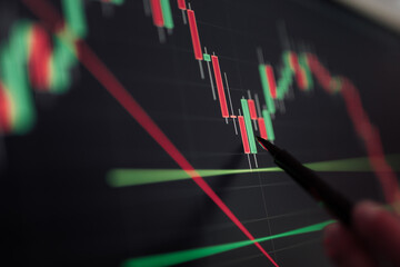 Crop trader working with financial charts on computer screen