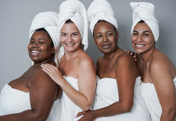 Beautiful multiracial women smiling on camera - Multi generational people doing skin care treatment...