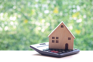 Estate tax,Model house on calculator with on natural green background,Business investment and...