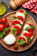 Fototapeta na wymiar Caprese salad with mozzarella, basil and garden tomatoes