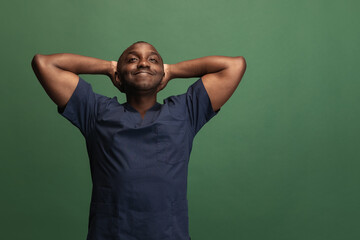 Fototapeta premium Image of african young doctor, therapeutic or medical advisor isoalted on green background. Concept of healthcare, care and medicine. Close-up