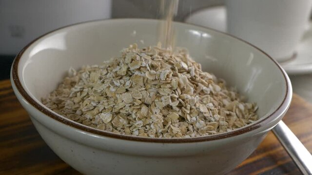 Pouring instant oatmeal into a bowl super slow motion