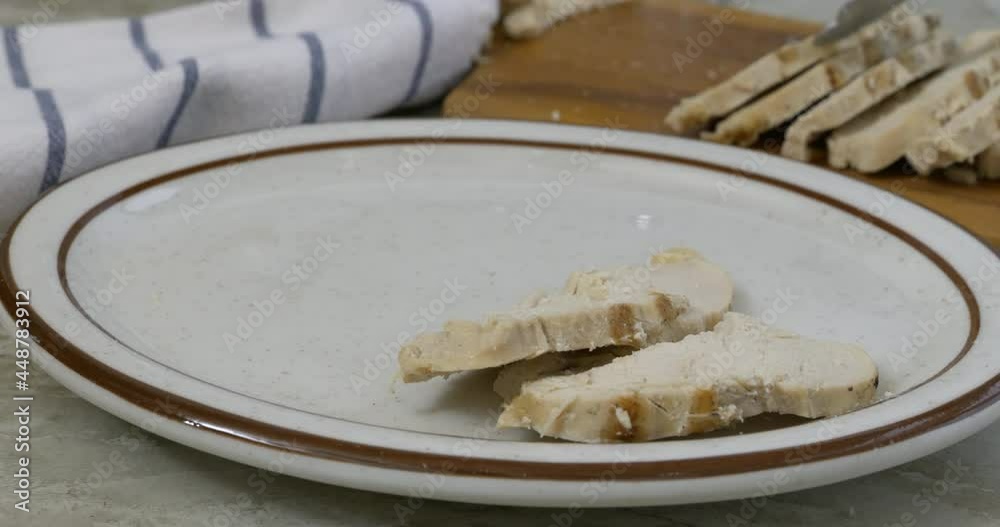 Poster serving slices of roasted chicken breast close up on a plate