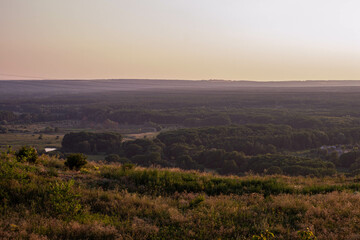 Fototapeta premium Panorama overlooking the city from the mountain at sunset. Ukraine, city of Izium August 2, 2021