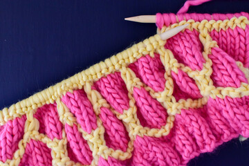 wool knitting and needles in bright colours and super chunky yarn 