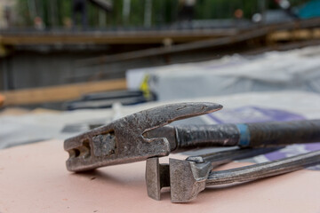 Construction tool. Hammer and nippers for monolithic work. Construction tool for mounting the frame for monolithic construction. A hammer. Nippers