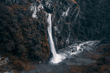 Aerial view of a huge waterfall between mountains