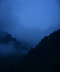 Foggy mountains landscape in night
