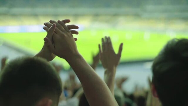 Fans at the stadium during the match. Slow motion