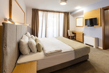 Interior of a luxury hotel double bed bedroom in the morning