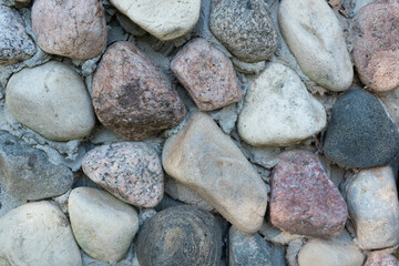 A background of beautiful multi-colored textured stones, fastened with cement.