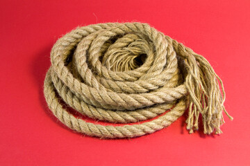 Front view shot with selected focus of Hemp rope on red background