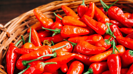 red chili pepper in a wooden basket and wooden background for preparation