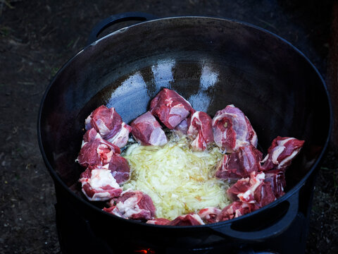 To Roasted Onions In Cauldron Are Added Pieces Of Lamb, Which Are Roasted To Obtain A Golden Crust.