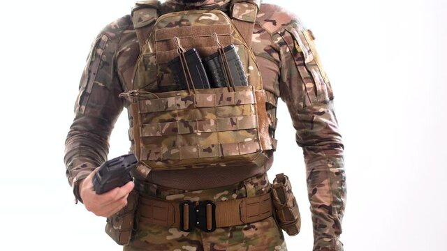 Soldier in plate carrier with rifle magazines 