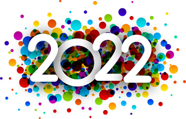 2022 white sign over colourful confetti.