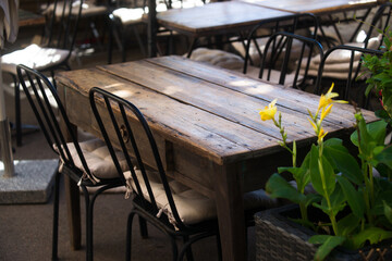 Old wooden table and vintage chairs in bar, restaurant in the South of France