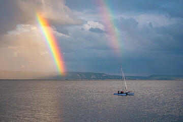 A bright double rainbow over the river