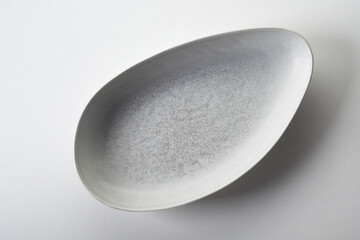 Oval ceramic serving platter on white background