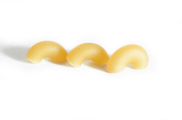 Three macaroni horns isolated on a white background. Macro. Horn