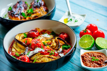 Grilled eggplant with tomatoes and bell pepper in a bowl