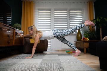 Exercise for balance and leg, arm, and abdominal muscles. Young woman workout.