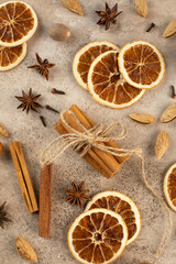 Cinnamon sticks, slices of dried orange, star anise. Top view. Autumn background. The concept of celebrating Christmas.
