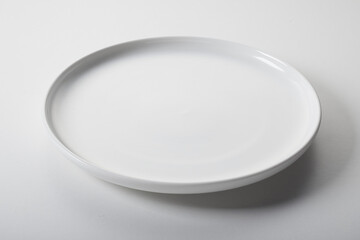 Round white plate on table - 448807557
