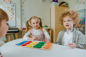 Preschool students sorting wooden geometric forms