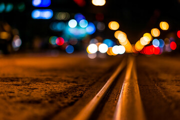 Night highway with rails, cars go over it. View from the level of asphalt