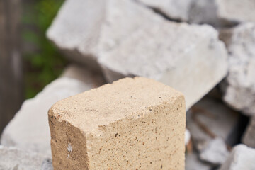 Stone podium. The pedestal is made of natural stone of beige color, on a stone background. High quality photo
