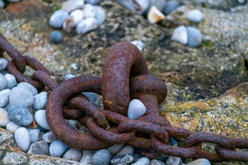 Fragment of old anchor chain on stone background. Marine theme and style. High quality photo