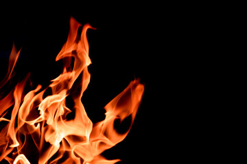 Orange flame on black background. Heat energy heap closely, red and yellow