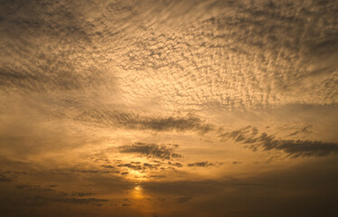 dramatic clouds float across the blue sky