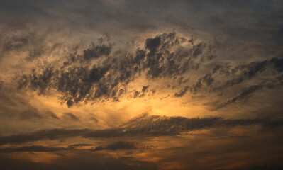 dramatic clouds float across the blue sky