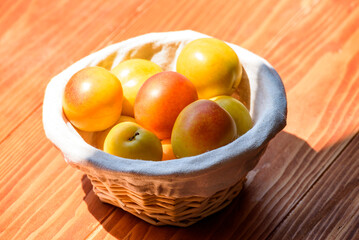 Mirabelle Plums in a basket on a wooden table