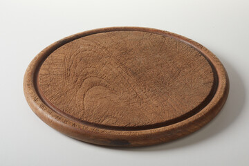 Round wooden board on table